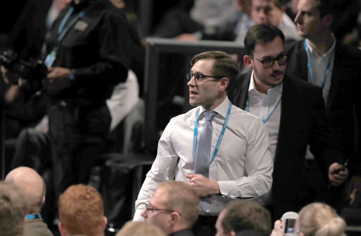 Comedian Simon Brodkin, also known as Lee Nelson is led out of the Conservative Party Conference hall.