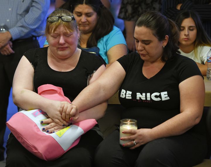 Heidi Antonacci (L) and her daughter Jessica Adsit, both of Nevada, attend a prayer vigil held at Mountain Crest Park for the victims of Sunday night's shooting