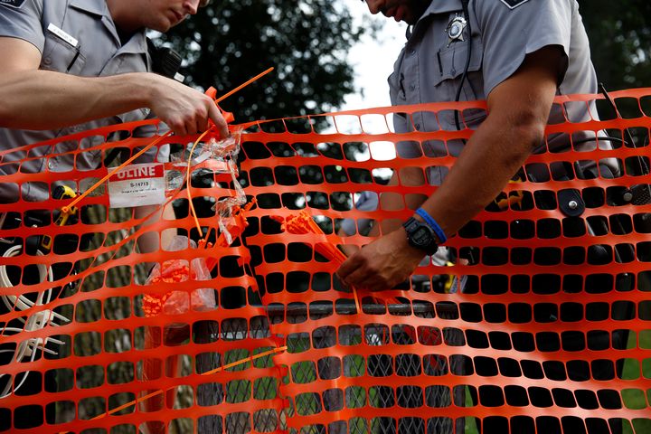 Members of the Milwaukee County Sheriff's department erect a fence around Sherman Park after disturbances following the police shooting of a man in Milwaukee, Wisconsin, U.S. August 15, 2016. REUTERS/Aaron P. Bernstein