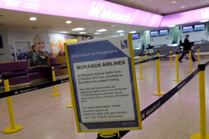 A notice is displayed at before empty Monarch Airlines check-in desks at Birmingham Airport