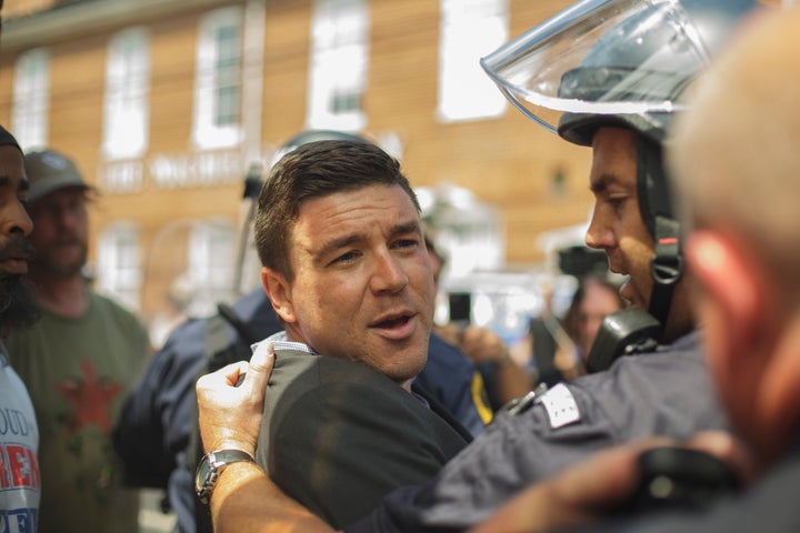 Jason Kessler is forcibly removed by Virginia state police during an attempted press conference in the wake of a deadly white supremacist rally in Charlottesville.