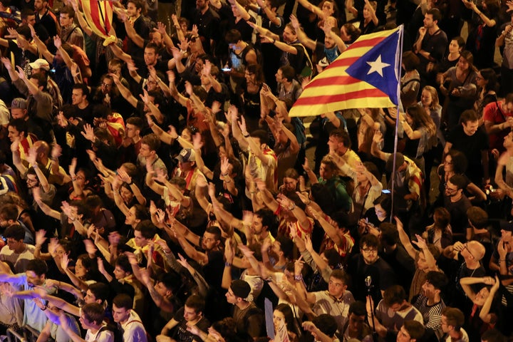 People raise arms and shout during a demonstration two days after the banned independence referendum in Barcelona, Spain, October 3, 2017.