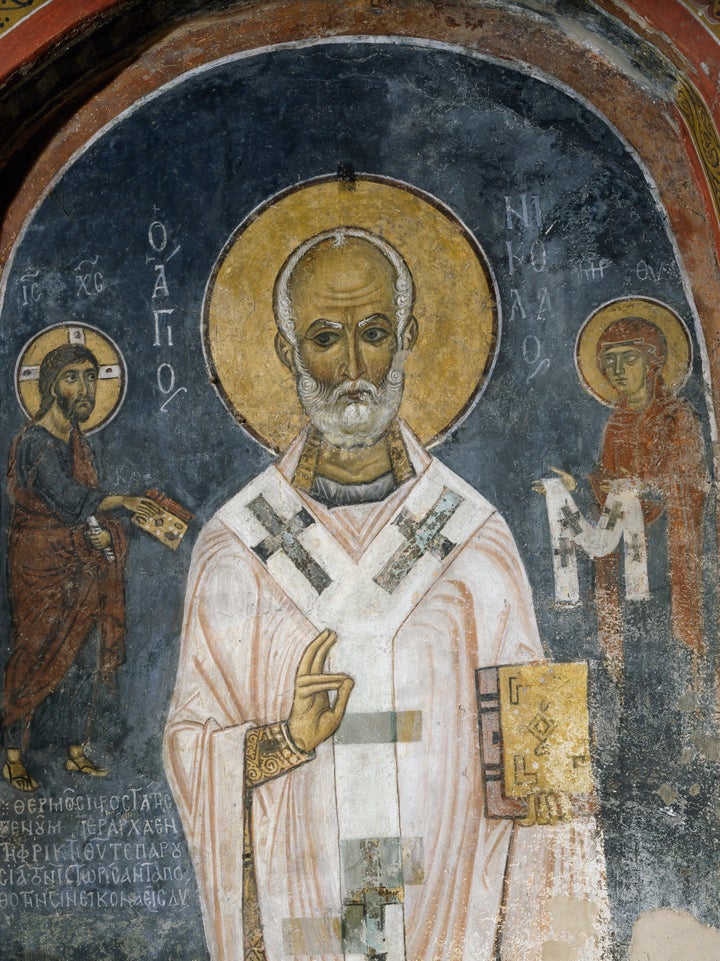 St. Nicholas of Myra is seen in this 12th-century fresco. The saint's acts of generosity, particularly to children, inspired the red and white-suited figure known as Santa Claus.