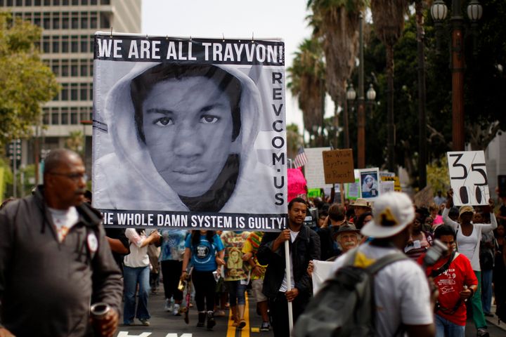 People carry a photo of Trayvon Martin during a march to protest the verdict in the George Zimmerman trial, after he was acquitted of shooting Martin dead. Young black men are far more likely to be killed by gunfire than white men