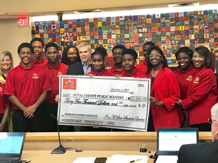 I'm A Star teens presenting a check to help Jacksonville's 2,700 homeless students.