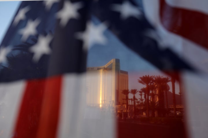 The Mandalay Bay hotel is shown through an American flag blowing in the wind at a memorial next to the mass shooting site along the Las Vegas Strip in Las Vegas, Nevada, U.S., October 4, 2017.