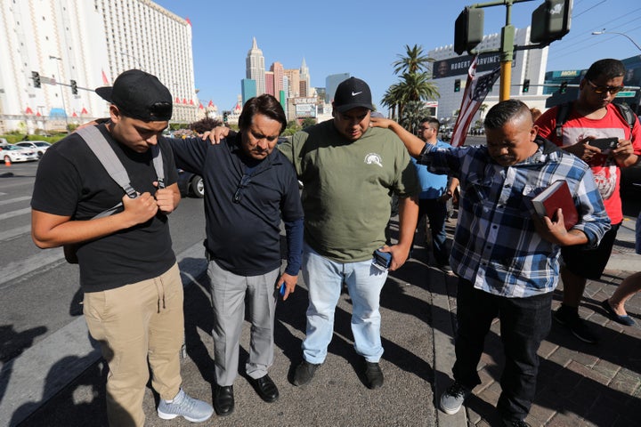 A group of men pray at a makeshift memorial in the middle of Las Vegas Boulevard following the mass shooting in Las Vegas, Nevada, U.S., October 4, 2017.