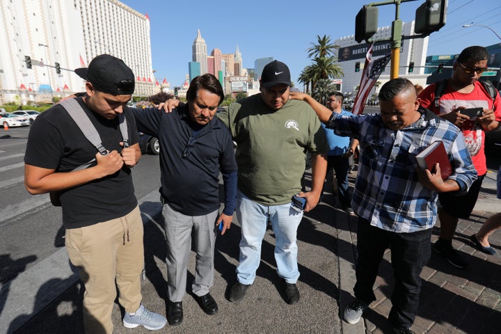 A group of men pray at a makeshift memorial in the middle of Las Vegas Boulevard following the mass shooting in Las Vegas, Nevada, U.S., October 4, 2017. 