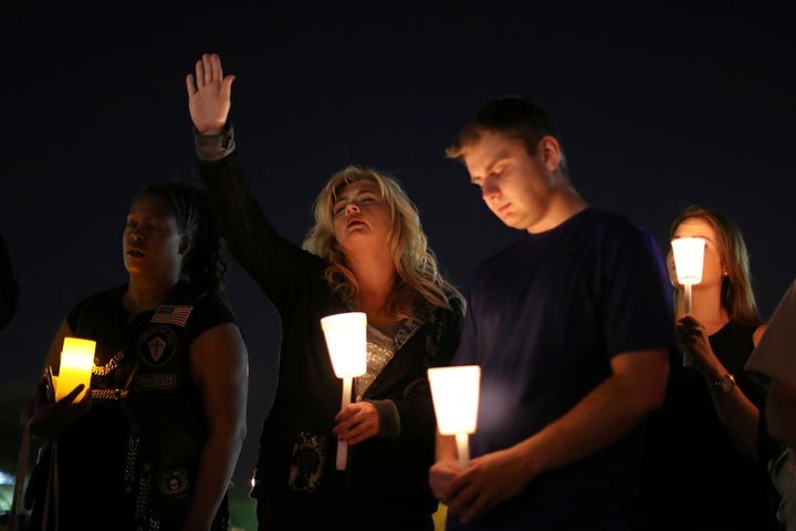 People pray during a candlelight vigil for victims of the Route 91 music festival mass shooting next to the Mandalay Bay Resort and Casino in Las Vegas, Nevada, U.S. October 3, 2017.