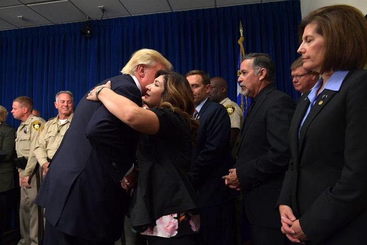 President Donald Trump salutes first responders as he visits the Metropolitan Police Department command center in Las Vegas o