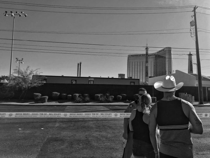 A couple speaks to a Las Vegas police officer guarding the perimeter of the Route 91 festival site Monday in Las Vegas.