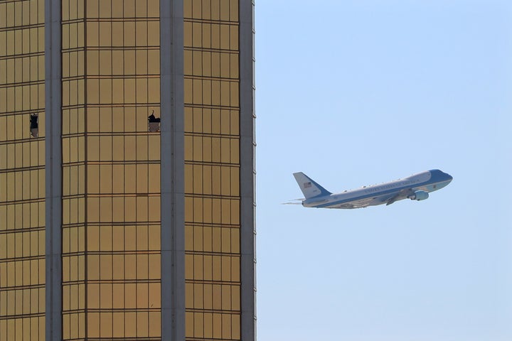 Air Force One departs Las Vegas past the broken windows on the Mandalay Bay hotel, where shooter Stephen Paddock conducted hi