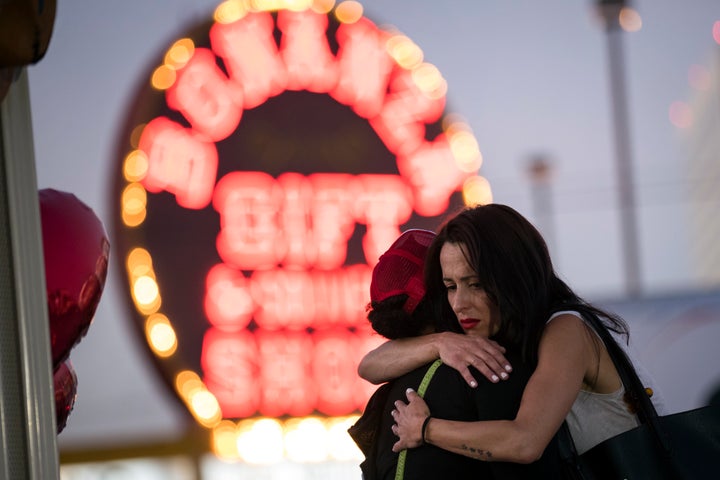 Two women hug at a makeshift memorial at the northern end of the Last Vegas Strip on Wednesday. 