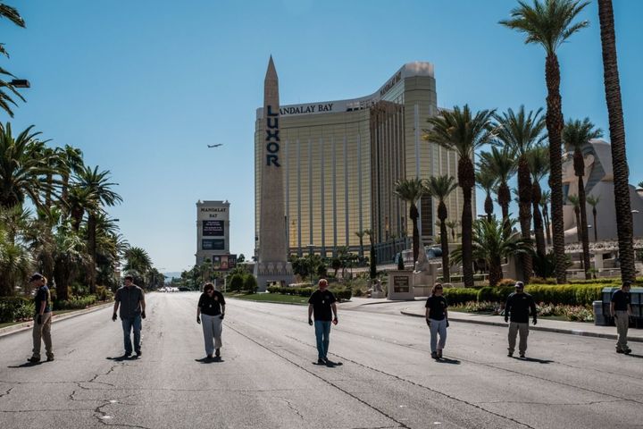 Members of the FBI sweep a stretch of South Las Vegas Boulevard which is still closed to the public near the Mandalay Bay Hotel and the site of the Sunday mass shooting that claimed the lives of 58 people and injured hundreds more in Las Vegas.