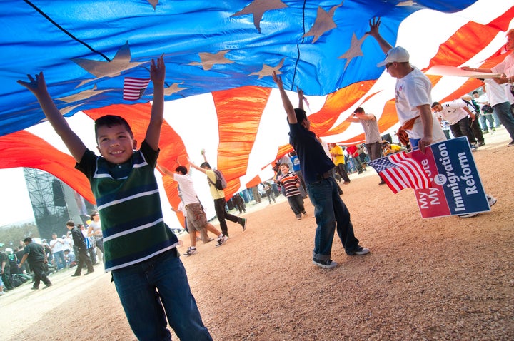 Washington, DC, USA - March 21, 2010: Children play under a giant American flag as some 200,000 immigrants' rights activists converge on the National Mall to demand comprehensive immigration reform.