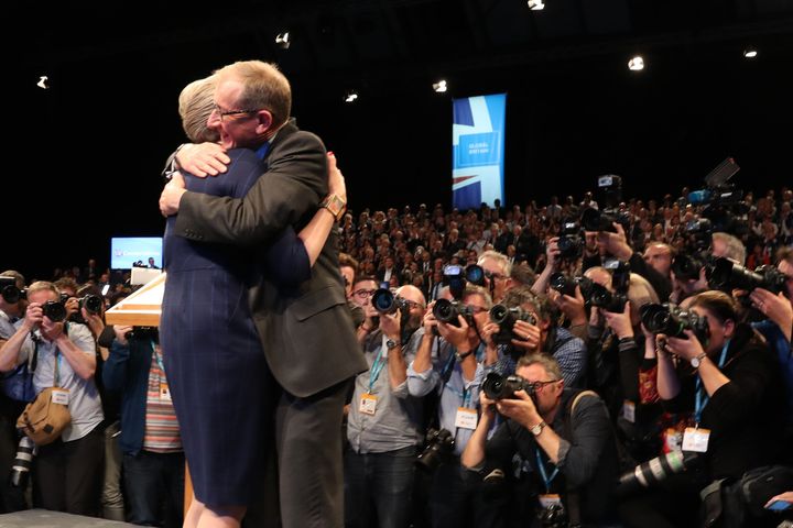 Husband Philip hugs Theresa May after her conference speech.