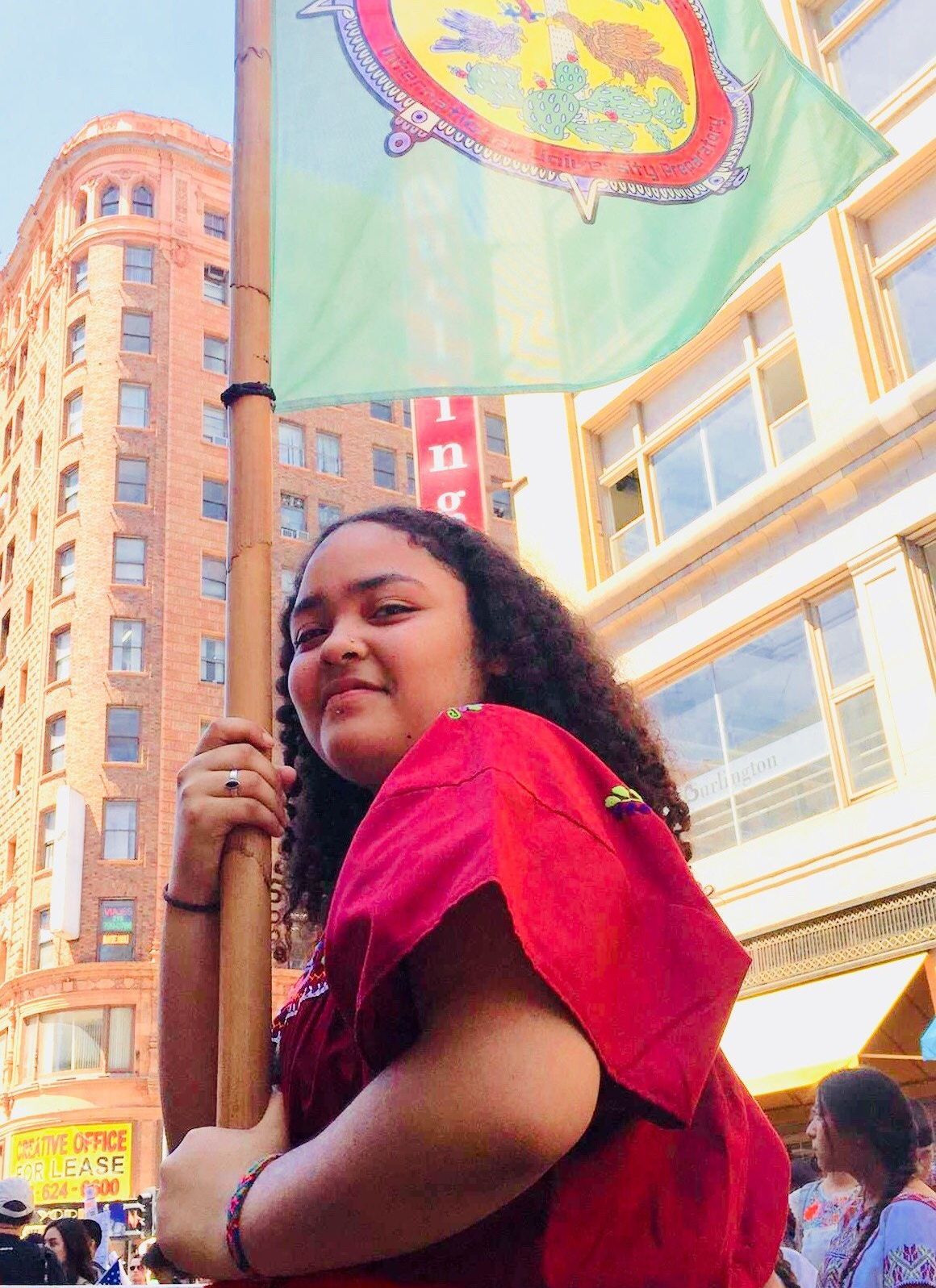 Ja-Rey Kilpatrick, in downtown Los Angeles during the May Day march for undocumented people, acts as a standard bearer for Semilla Community Schools.