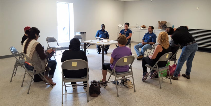 Several survivors of Hurricane Harvey sit together as they receive acupuncture.