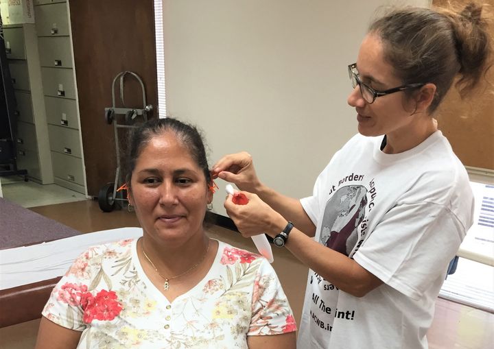 A Hurricane Harvey survivor receives acupuncture from a volunteer.