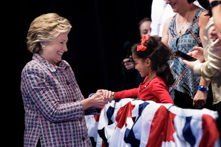 Hillary Clinton meets a child during her presidential run at the Sunrise Theatre in Fort Pierce, Florida.