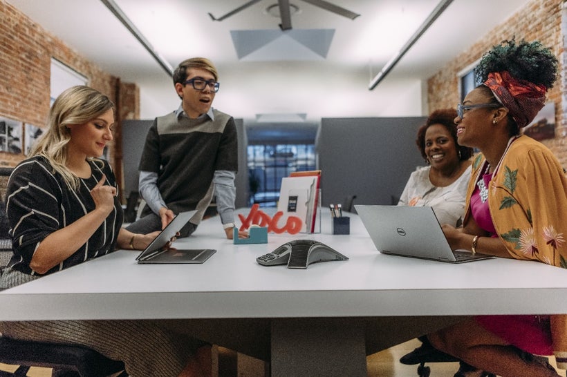 Rakia Reynolds, CEO of Skai Blue Media, works with her team.