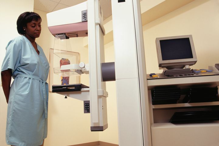 A woman prepares herself for a mammogram. Breast cancer rates are improving in the U.S., but black women still have lower chances of surviving the disease.