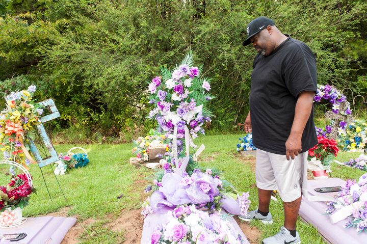 Vincent Mitchell looks at his wife's grave at a cemetery in Bogue Chitto.