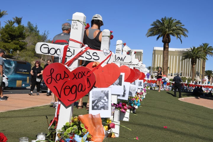 Mourners decorate the crosses. 