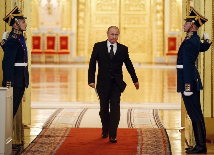 Russian President Vladimir Putin enters a hall to attend a meeting dedicated to the organization of upcoming events and celebrations on Victory Day at the Kremlin in Moscow.