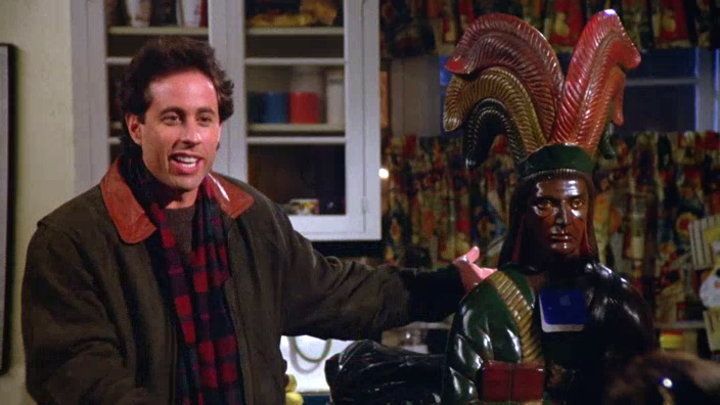 Jerry Seinfeld with a cigar store Indian statue.