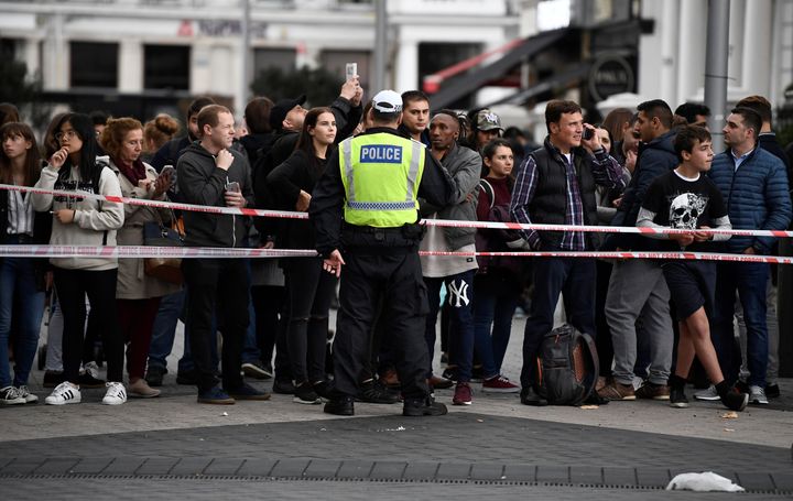 A police officer stands at a cordoned off area near the museum