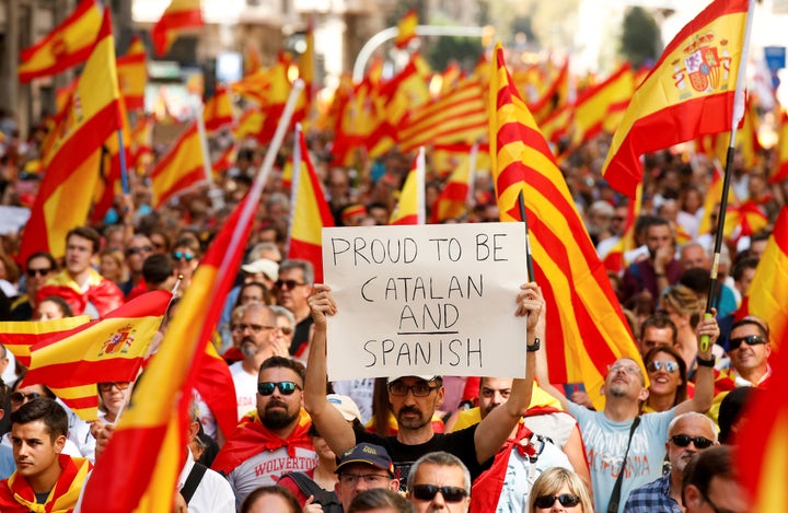 A man holds up a sign while attending a pro-union demonstration organised by the Catalan Civil Society organisation in Barcelona, Spain, October 8, 2017. 