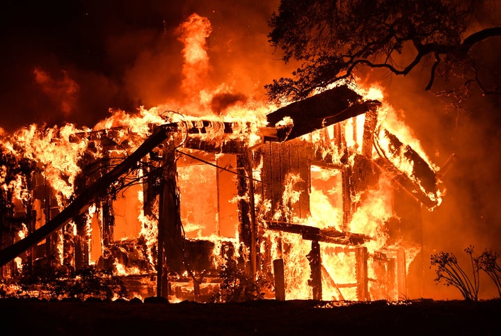 Flames ravage a home in the Napa wine region in California on October 9, 2017, as multiple wind-driven fires continue to whip