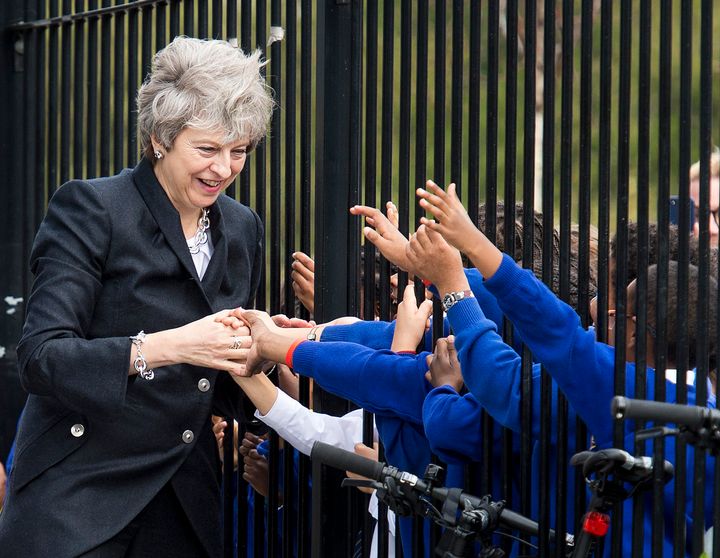 Theresa May is greeted by primary pupils during a visit to the Dunraven School in Streatham, south London, ahead of the publication of details of the Government's Race Disparity Audit.