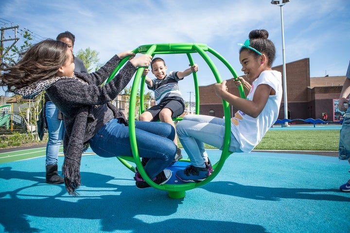 Children play in a schoolyard converted to a community playground in Philadelphia.