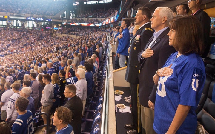 Vice President Mike Pence and second lady Karen Pence stand during the national anthem prior to the start of an NFL football game between the Indiana Colts and the San Francisco 49ers at the Lucas Oil Stadium in Indianapolis, Oct. 8, 2017.