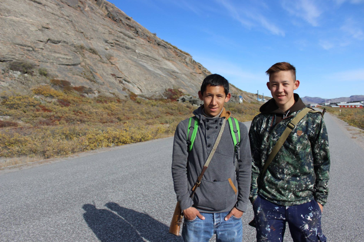 Knud Lyberth, left, with his brother, Enos, on the road that cuts through Kangerlussuaq.