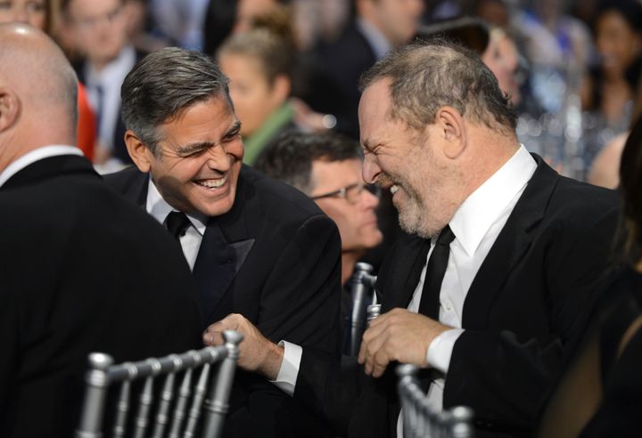 George Clooney and Harvey Weinstein share a laugh in 2013. Clooney called the accusations against Weinstein