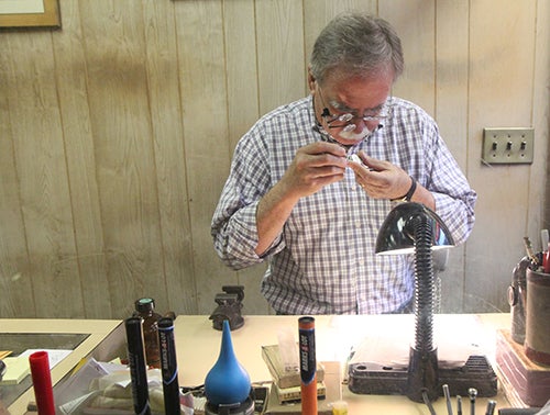 <p><strong>Marcel working on a watch.</strong></p>