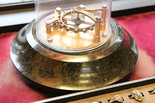 <p><strong>The escapement, made by Marcel’s father, stands in the center of Grand Jewelers’ window.</strong></p>