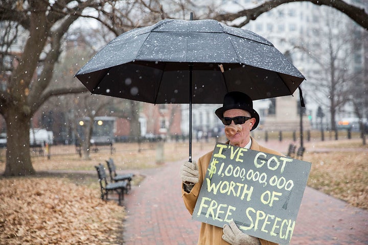 <p>David Barrows, of Washington, DC, holds a sign while he watches a rally calling for an end to corporate money in politics and to mark the fifth anniversary of the Supreme Court’s Citizens United decision</p>