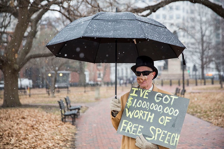 David Barrows, of Washington, DC, holds a sign while he watches a rally calling for an end to corporate money in politics and to mark the fifth anniversary of the Supreme Court’s Citizens United decision