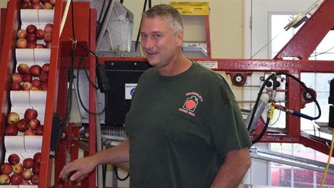 Dan Beardsley with a cider press at his apple farm in Shelton, Connecticut. He plans to distill apple brandy and whiskey unde