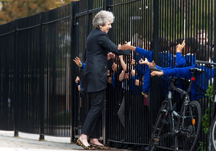 <strong>Theresa May is greeted by primary pupils during a visit to the Dunraven School in Streatham, ahead of the audit's publication</strong>
