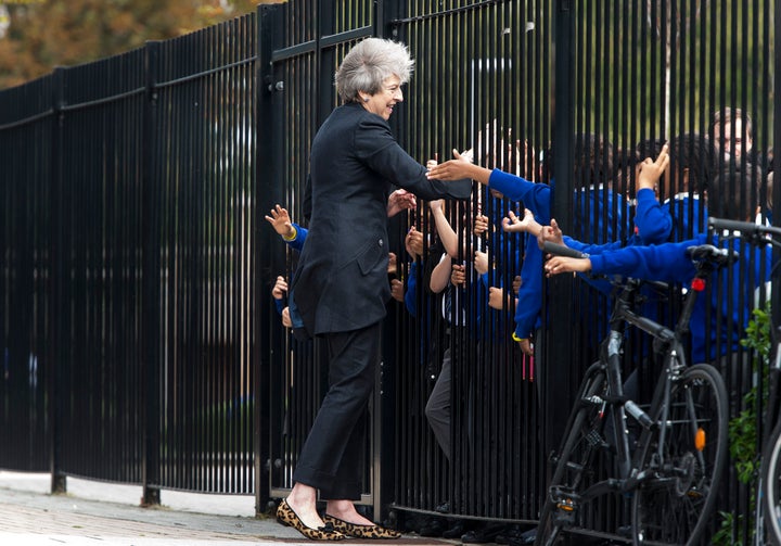 Theresa May is greeted by primary pupils during a visit to the Dunraven School in Streatham, ahead of the audit's publication