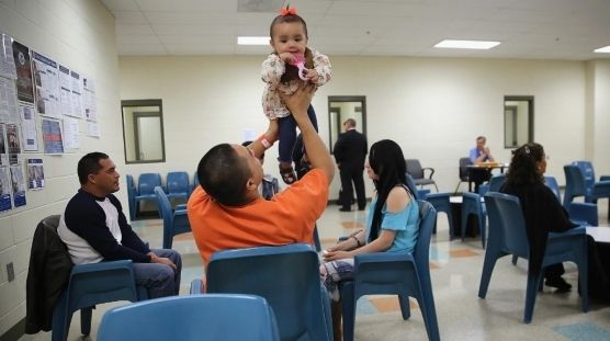 An inmate visits with his young daughter in prison.