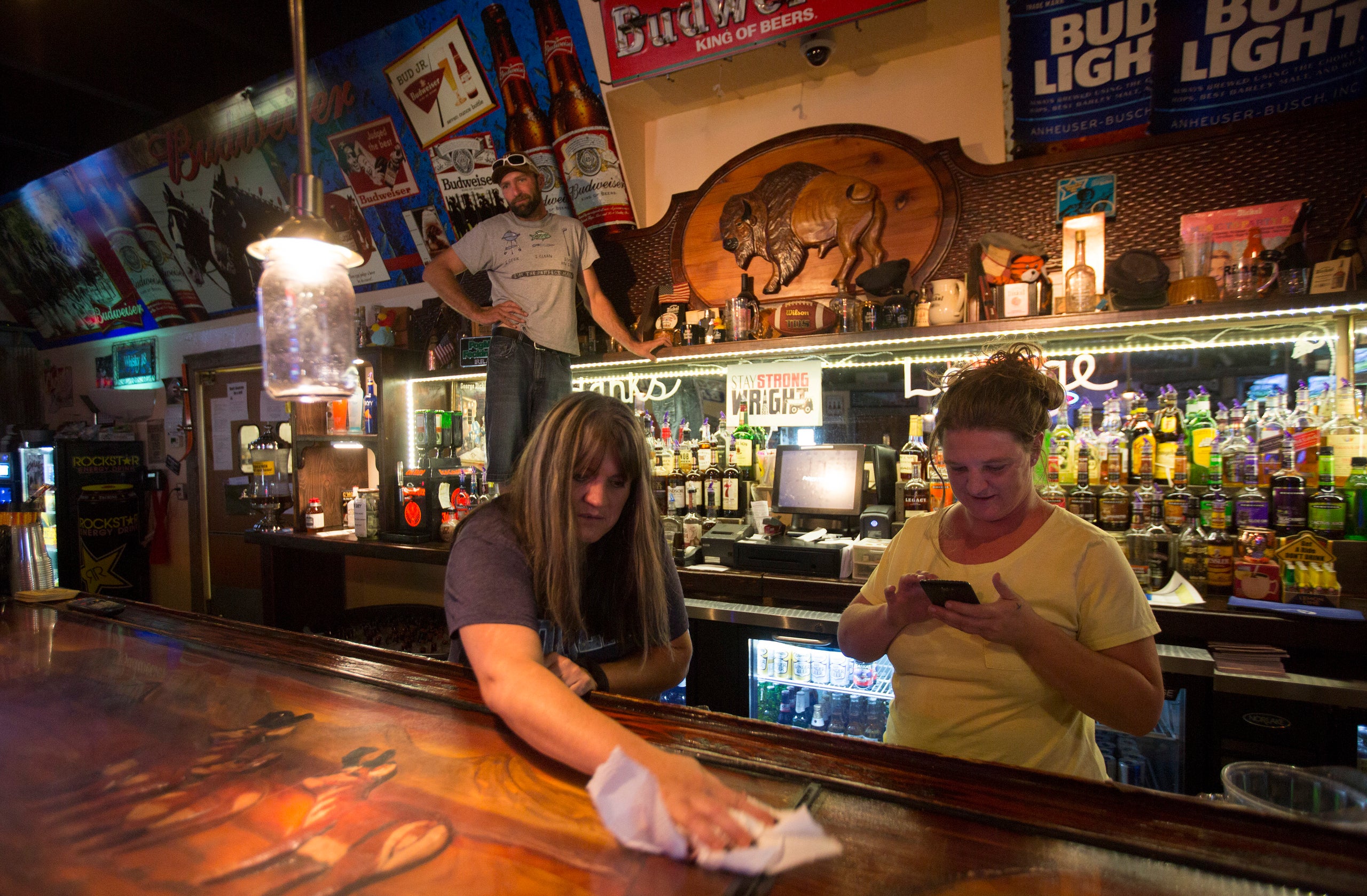 Lori Sanders, a bartender at Hank's Roadside Bar and Grill in Wright, wipes down the bar. “We don’t put