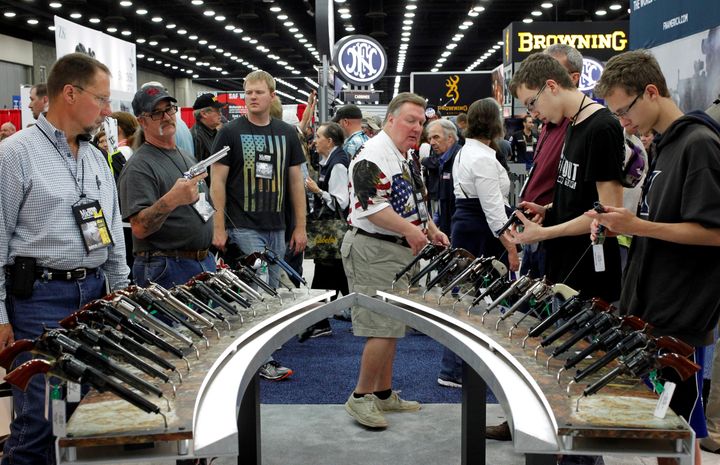 Gun enthusiasts look over Benelli USA guns at a National Rifle Association show in Louisville, Kentucky, May 21, 2016.