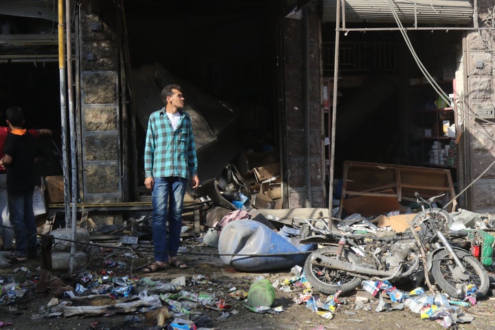 A Syrian resident looks at the damage following a reported airstrike on a vegetable market in Maaret al-Numan in Syria's northern province of Idlib, Oct. 8, 2017.