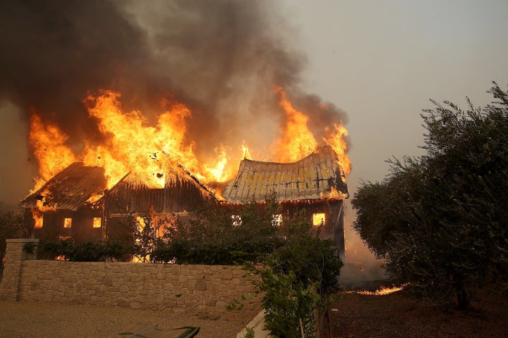 Fire consumes a barn as an out of control wildfire moves through the area on Oct. 9, 2017, in Glen Ellen, California.